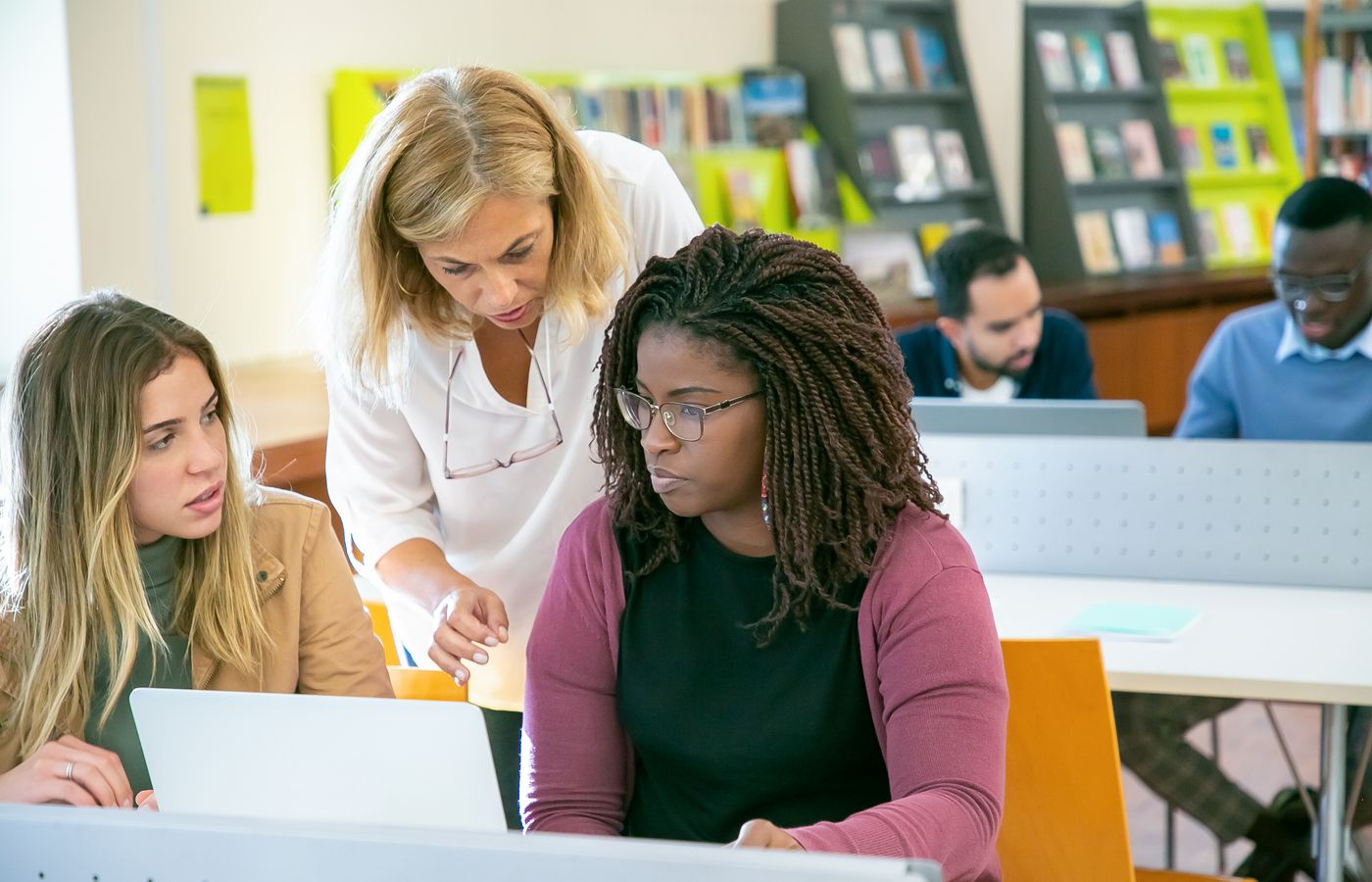 Educators working together on a laptop